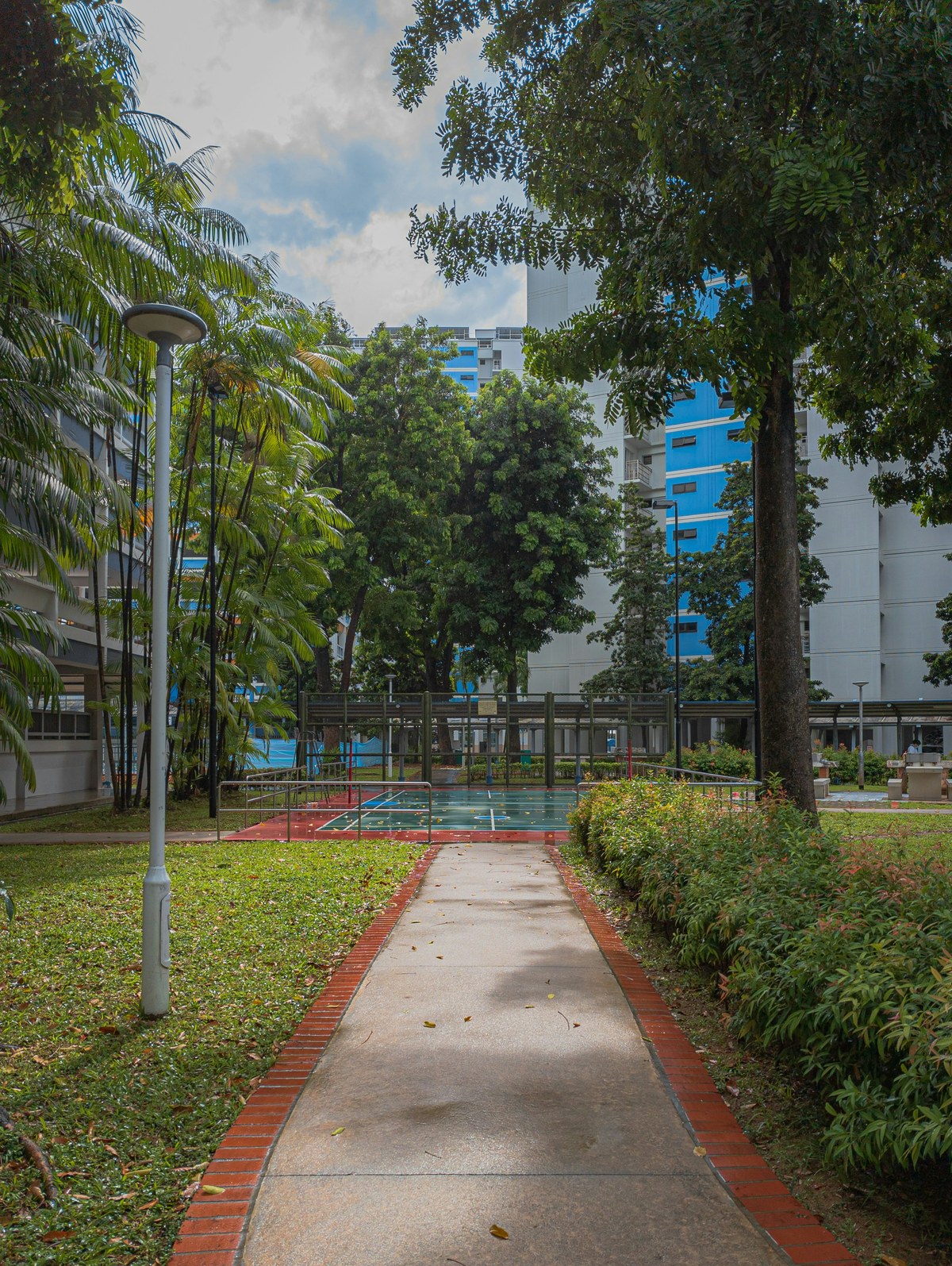 Evening at a Choa Chu Kang void deck, corridor lights and blocks in soft focus